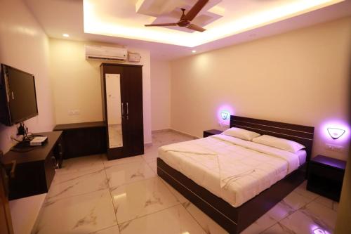 a bedroom with a bed and a ceiling fan at Aman Residency in Thodupuzha