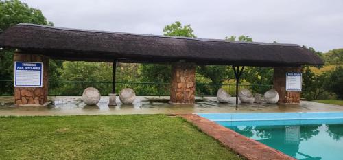 a pavilion next to a swimming pool in a park at Eagles Nest in Rustenburg