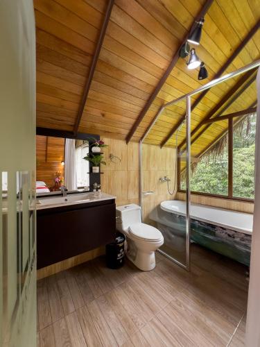 a bathroom with a toilet and a tub and a sink at Suchipakari Amazon Eco -Lodge & Jungle Reserve in Puerto Misahuallí