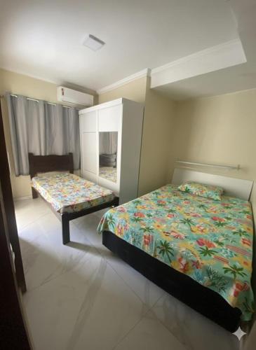 a bedroom with a bed and a bench in it at Casa do Arruda na tabuba in Caucaia