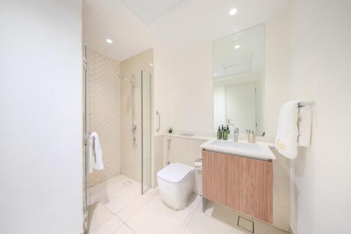 a bathroom with a toilet and a sink and a shower at Luxury Studio With Private Garden - Uptown Al Zahia Sharjah in Ḩiz̧āyib az Zānah