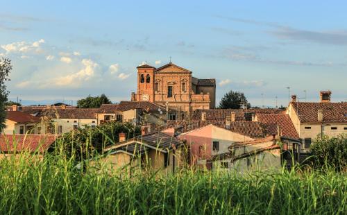 an old building with a clock tower in a city at B&B Le Tortore in Melara