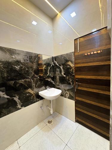 a bathroom with a sink and a shower at Hotel Pearl Nest Palace in Agra