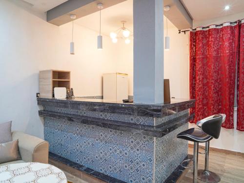 a living room with a fireplace with a red curtain at Agréable suite situé dans une villa in Rabat