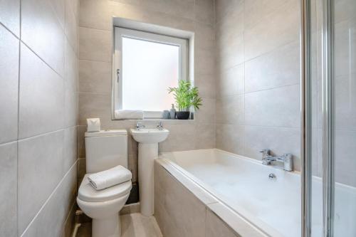 a bathroom with a toilet and a sink and a bath tub at 1 Bed in Middlesbrough oc-79273 in Great Ayton