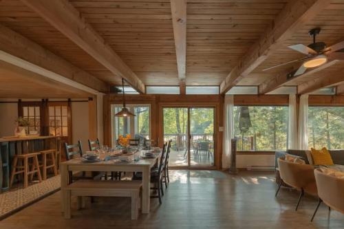 a dining room with a table and chairs at Riverfront Getaway with Hot Tub and Scenic Views in Mont-Tremblant