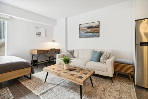 a living room with a couch and a table at Great Located Studio perfect for 2 with parking in Toronto