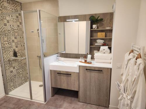 a bathroom with a sink and a shower at DOMITYS - Les Arilles in Ifs