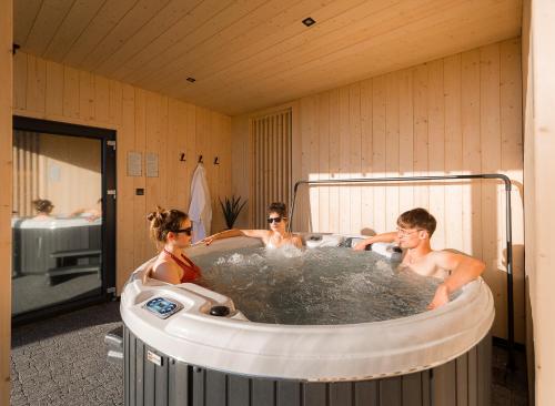 a group of people in a hot tub at Domki nad Zaporą w centrum Soliny przy Zaporze - wybrane domki z jacuzzi in Solina
