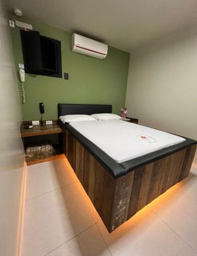 a bedroom with a large bed in a room at Lemonte Motel in Brusque