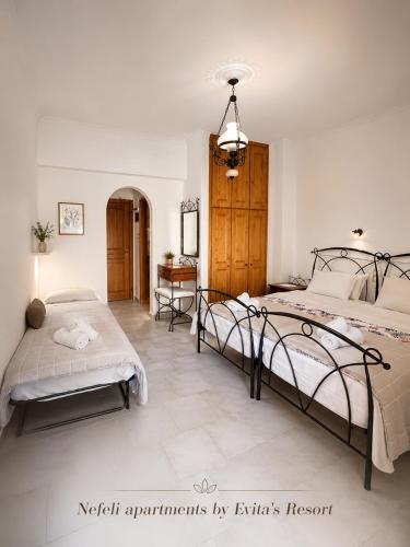 a bedroom with two beds and a desk at NEFELI by Evita's Resort in Poros