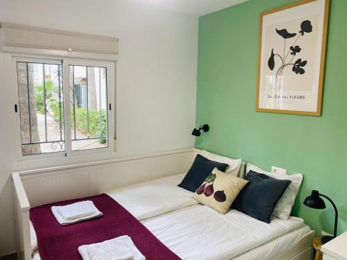 a small room with a couch with a window at Casa Verde - Ground floor apartment next to the beach in Torrox Costa