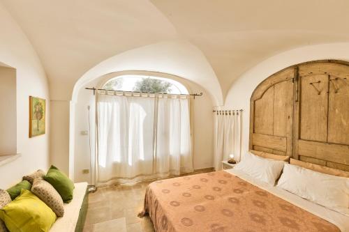 Ένα ή περισσότερα κρεβάτια σε δωμάτιο στο Terra Sessana Ville e Trullo con piscina privata