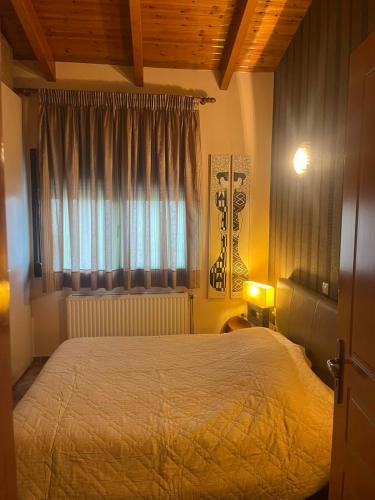 a bedroom with a large bed and a window at K-Loft Urban Athens in Pallini