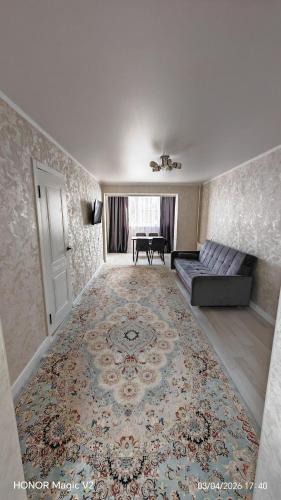 a living room with a couch and a rug at Aktau 4-31 in Aktau