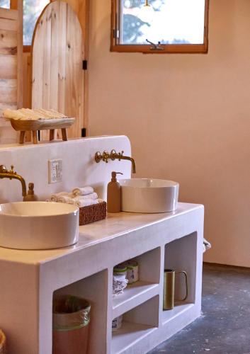 a bathroom with two sinks on a counter at Gatherwild Ranch in Germantown