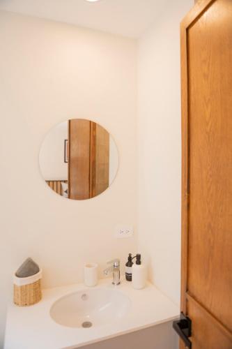 a bathroom with a sink and a mirror at Patio 7 Studios in San Miguel de Allende