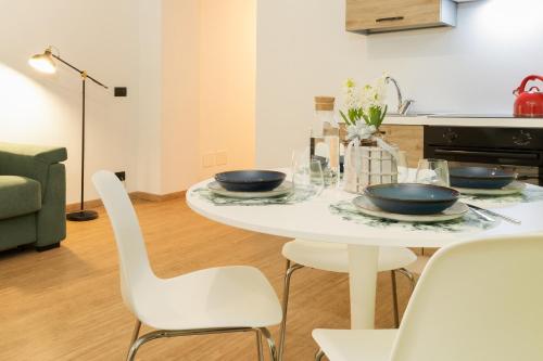 a white table with two bowls on it in a kitchen at NEW Tocai – in via Rastello per 4 pp in Gorizia