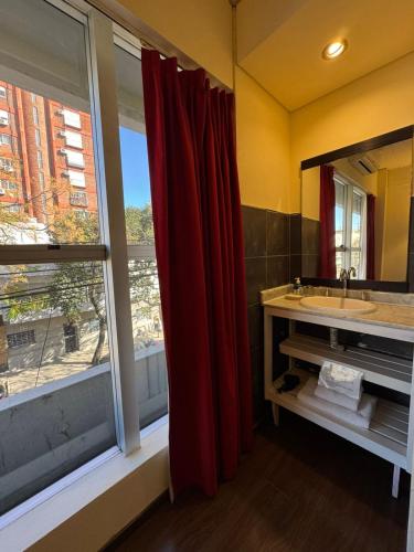 a bathroom with a sink and a large window at First Palermo Hotel in Buenos Aires