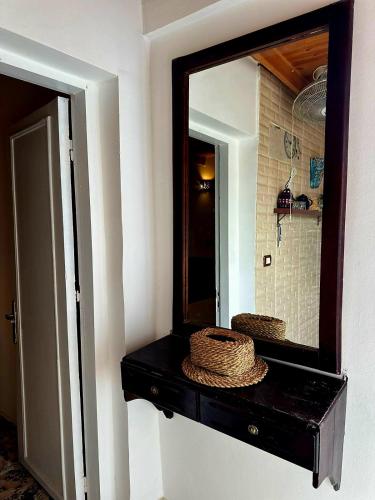 a bathroom with a mirror and a black vanity at Moroohouse in Dahab