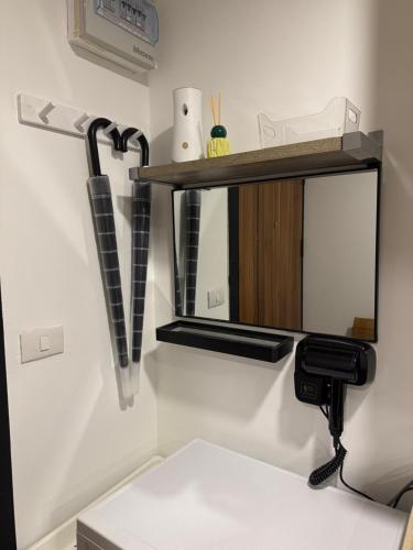 a mirror on a wall with a hair dryer at Sunset view apartment with a pool MAIKHAO Phuket in Ban Mai Salae