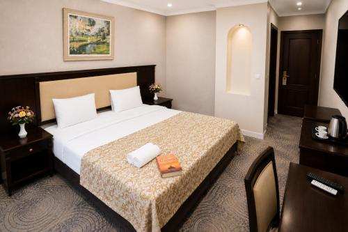 a hotel room with a bed and a television at Premier Hotel in Baku