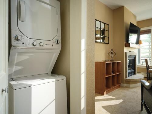 a kitchen with a washer and dryer in a room at The Residences at Mountain Lodge by Hyatt Vacation Club in Beaver Creek