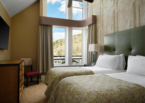 a hotel room with two beds and a window at The Residences at Mountain Lodge by Hyatt Vacation Club in Beaver Creek