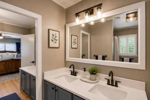 a bathroom with two sinks and a large mirror at Pub, Hot Tub, Game Room, Monkey Island Waterfront in Afton