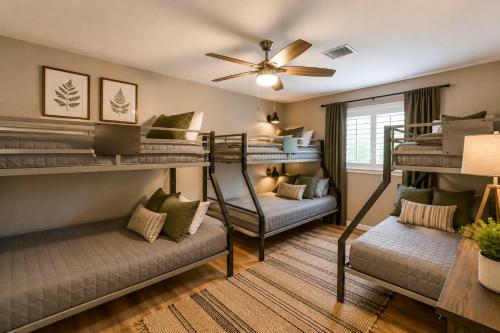 a room with four bunk beds and a couch at Pub, Hot Tub, Game Room, Monkey Island Waterfront in Afton
