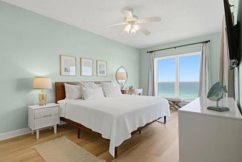 a bedroom with a bed and a window with the ocean at Riviera Dunes 503 in Perdido Key