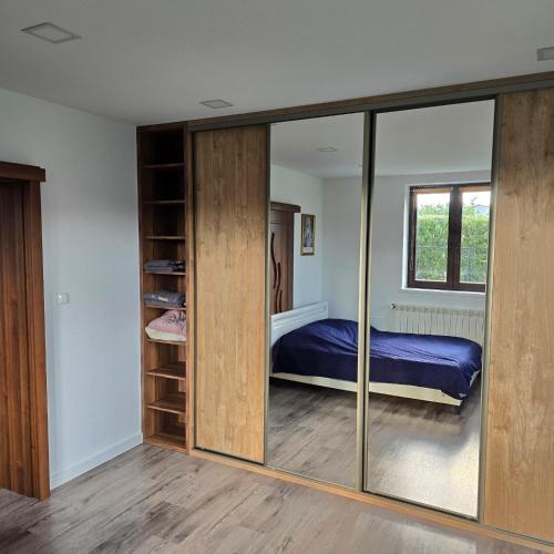 a bedroom with sliding glass doors and a bed at Apartament WLA in Barcice