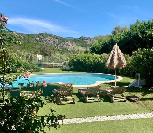 a swimming pool with chairs and an umbrella at Cruciata in Pietrosella