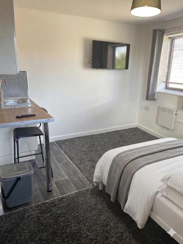 a bedroom with a bed and a desk and a sink at Jayden house in Middlesbrough