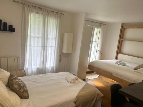a bedroom with two beds and a window at Studio Disney Paris in Bailly-Romainvilliers