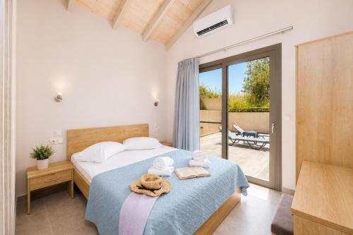 a bedroom with a bed with towels on it at Villa Gerasmia in Trapezaki
