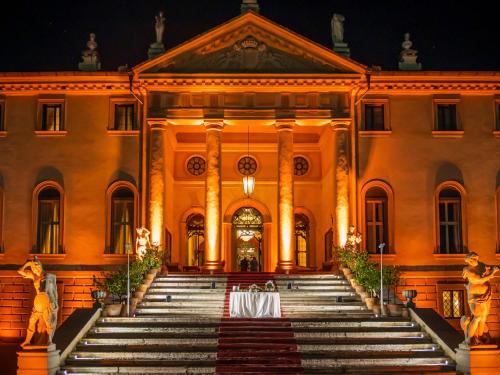 a large building with a table on the stairs at Hotel Villa Cornér della Regina - Buongiorno! Hotels in Vedelago