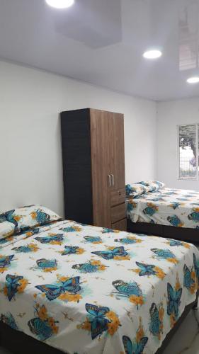 a bedroom with two beds and a dresser at Pachamama House in Bucaramanga