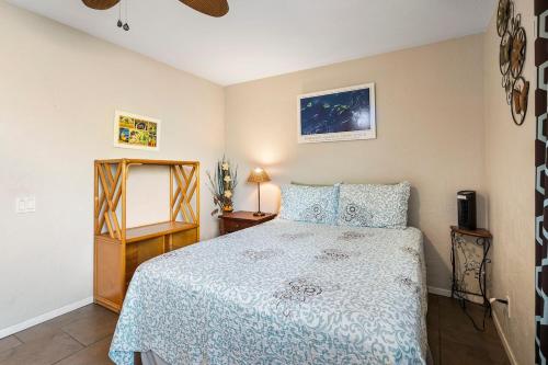 a bedroom with a bed and a dresser and a mirror at KONA - Royal Kahili B205 End Unit - Gorgeous Views in Kailua-Kona
