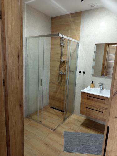 a bathroom with a shower and a sink at u Harrego in Dębki