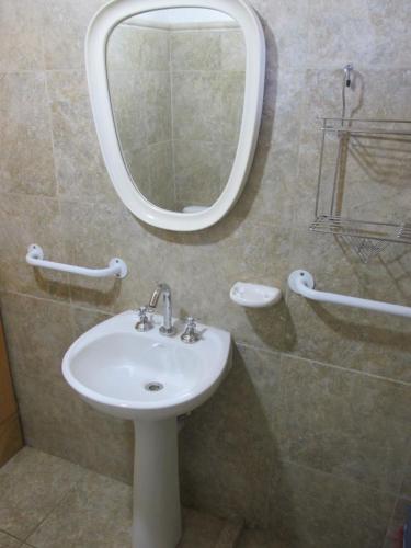 a bathroom with a sink and a mirror at Cabañas El Muelle in Cholila