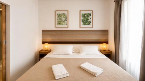 a bedroom with a bed with two towels on it at INT Lisbon Suites in Lisbon