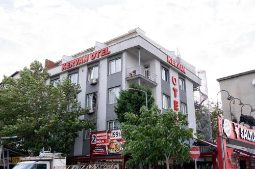 a white building with a red sign on it at Kervan Hotel Pendik in Istanbul