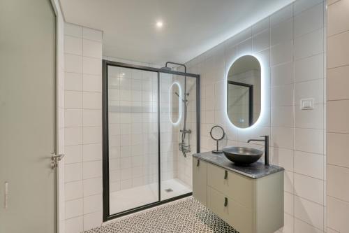 a bathroom with a sink and a shower at Chapelaria Boutique Hotel in Funchal