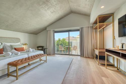 a bedroom with a bed and a large window at Chapelaria Boutique Hotel in Funchal