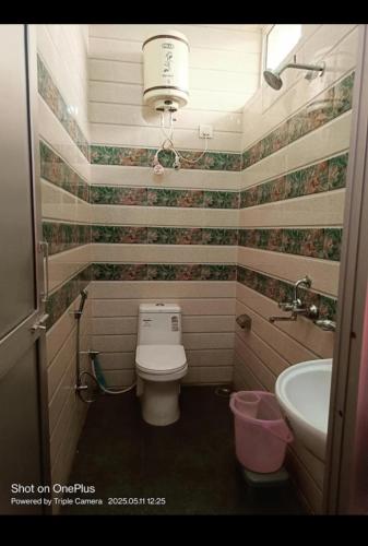 a bathroom with a toilet and a sink at Shree mangalam homestay in Bhīm Tāl