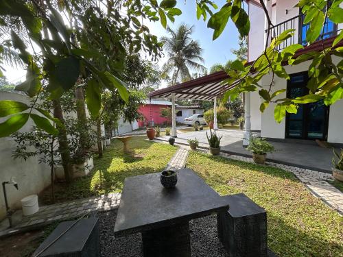 a stone bench in the yard of a house at Slow Life Coliving, Hiriketiya in Dickwella