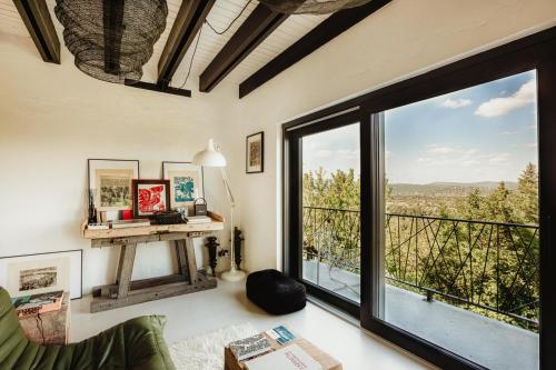 a living room with a large window with a view at helloduna in Dunabogdány