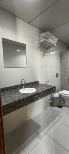 a bathroom with a sink and a toilet at Hotel La Costa in Rio de Janeiro