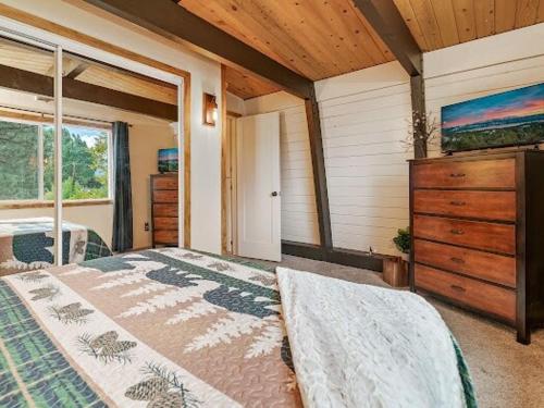 a bedroom with two beds and a dresser in a room at Cozy Pet Friendly Big Bear Cabin in Big Bear City